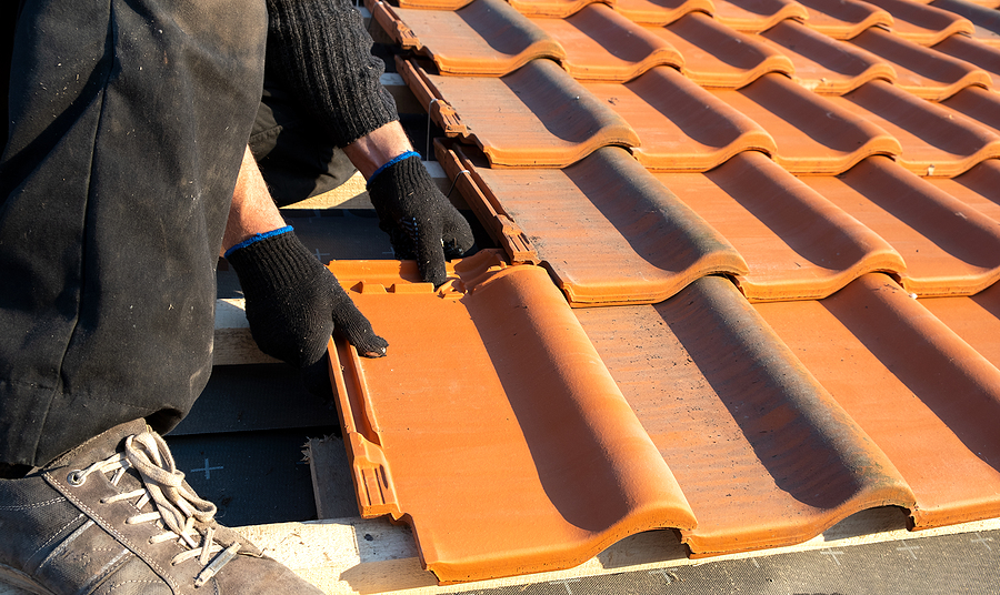Worker installing roof tile recyclers